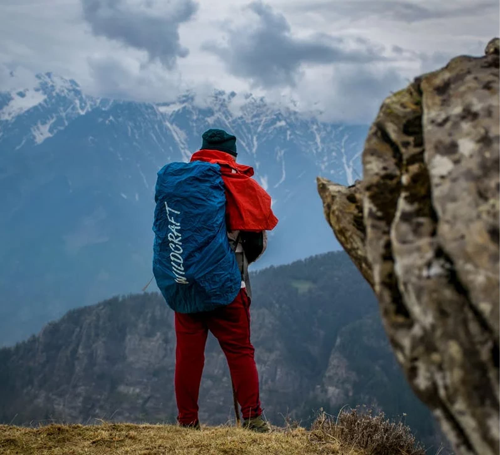 Traveler looking toward snowy mountains in Switzerland