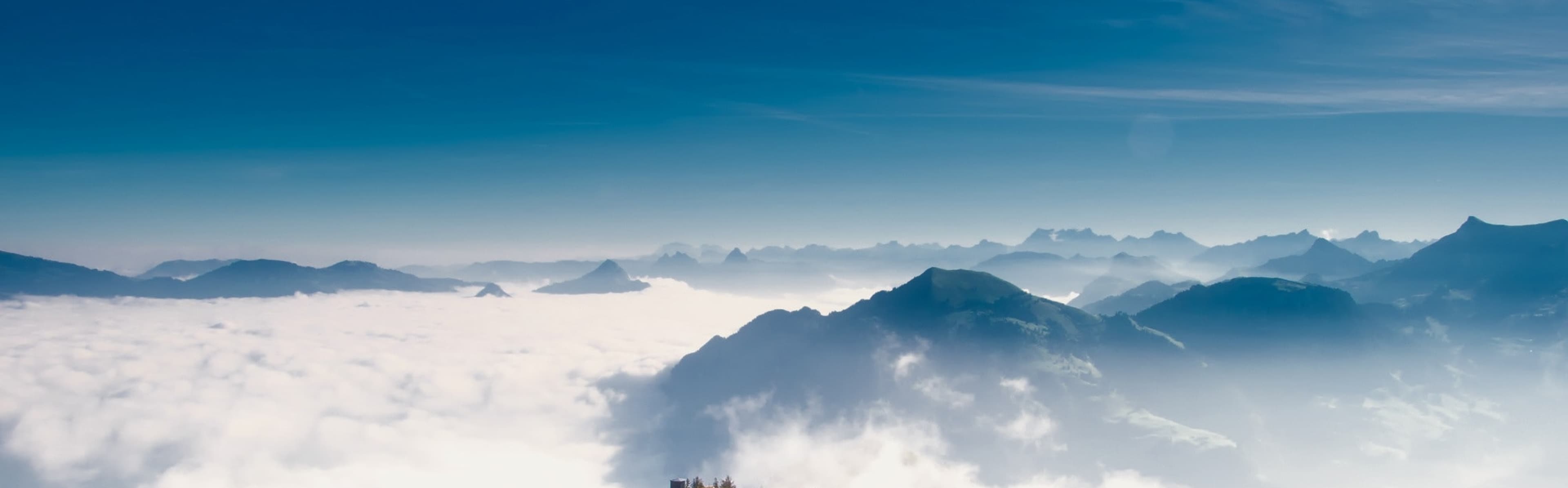 Mountain peaks rising above a sea of clouds
