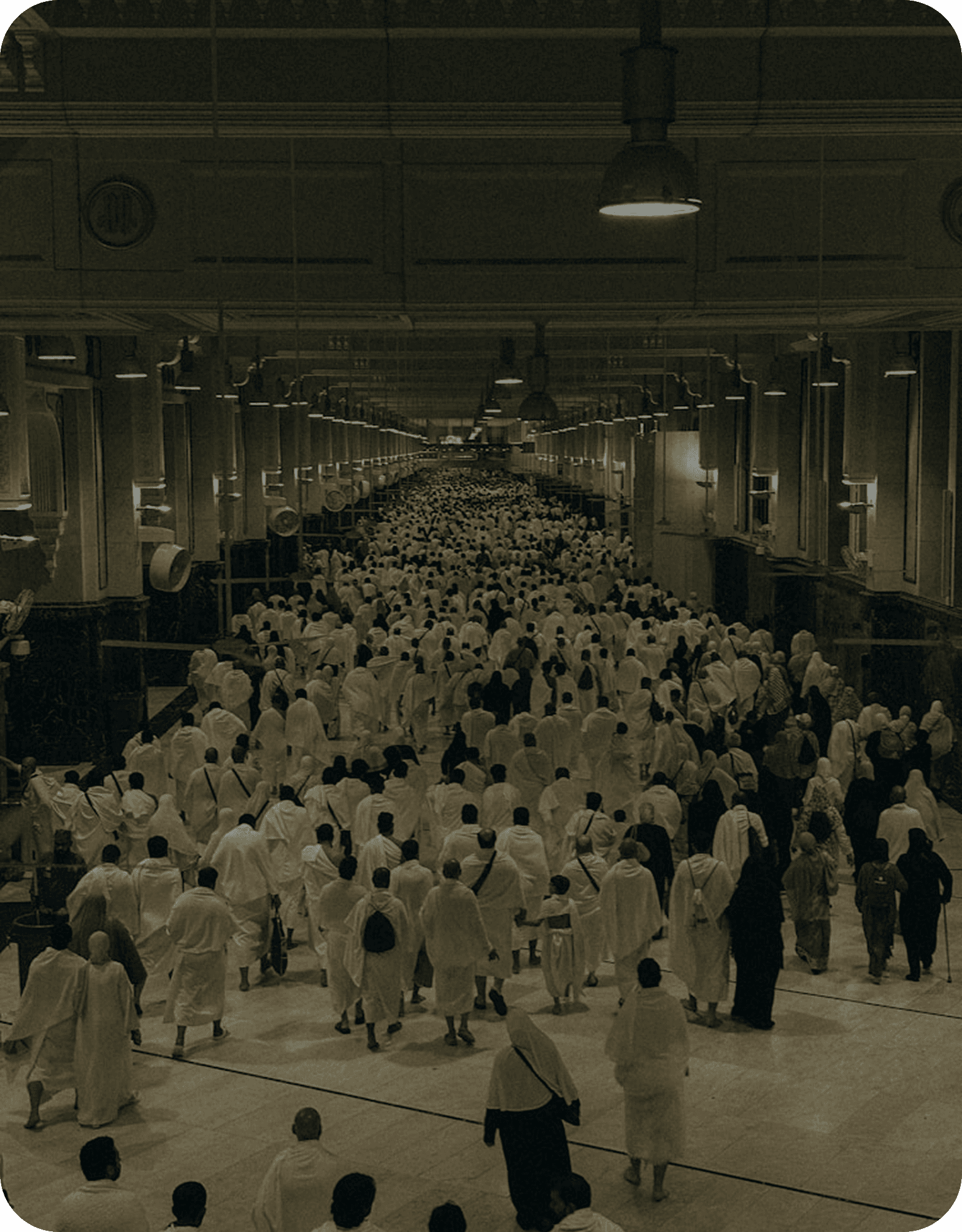 Pilgrims walking through a covered Hajj corridor