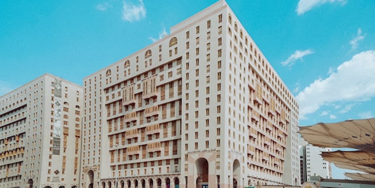 Hotel buildings in Makkah under a bright blue sky