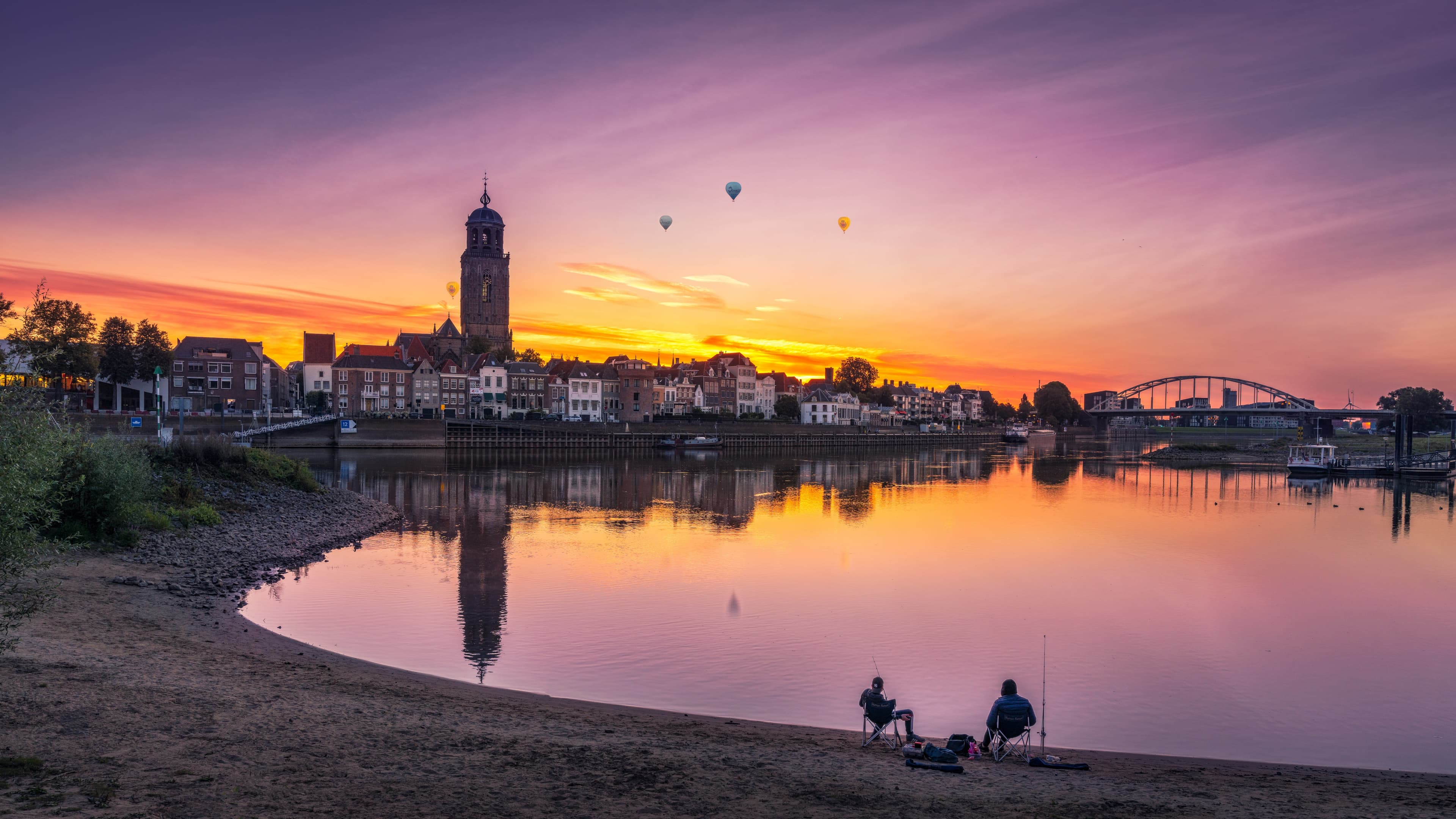 A European riverside city at sunset